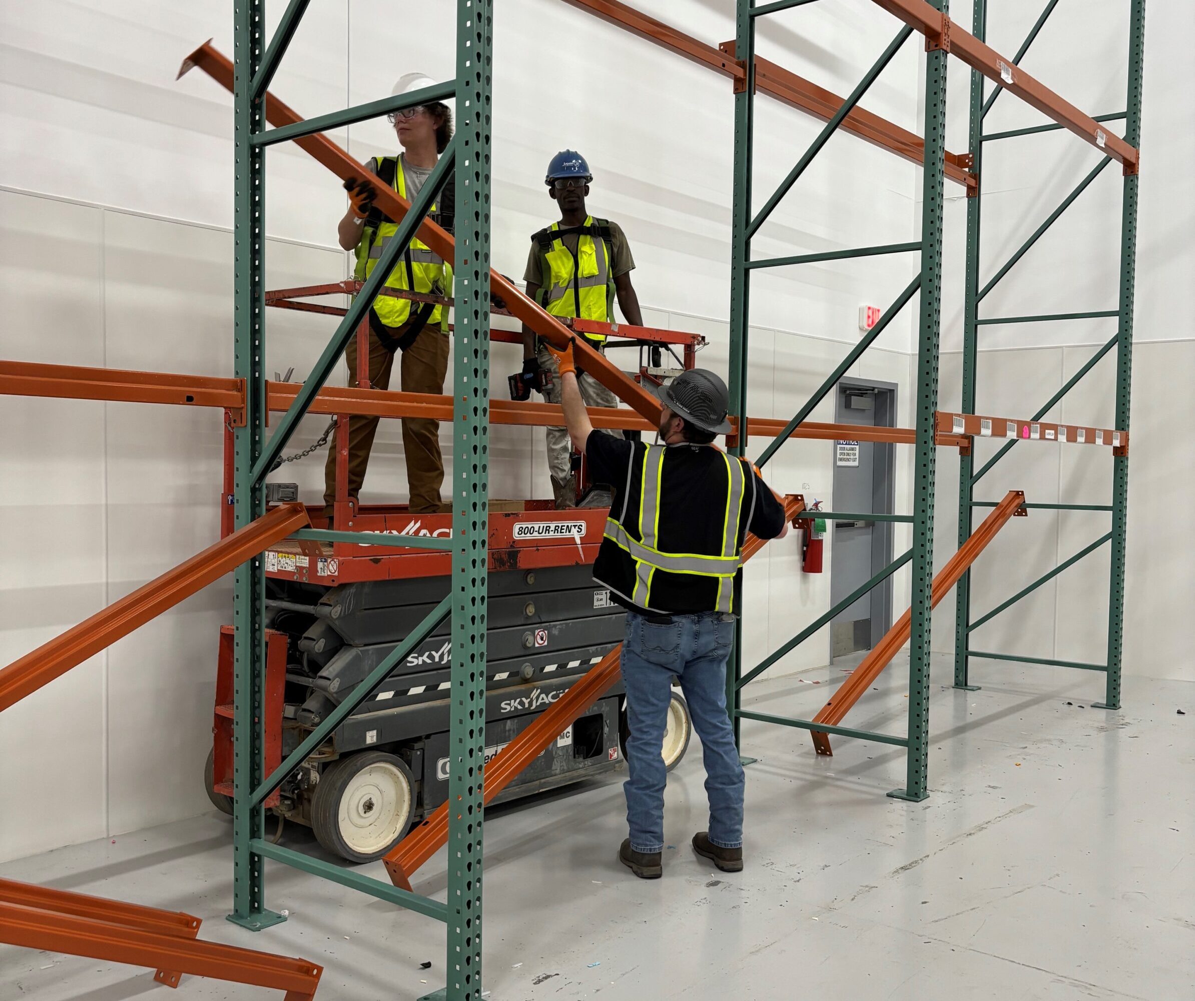team members putting together a vertical storage rack