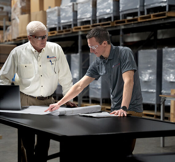 two team members consulting each other
